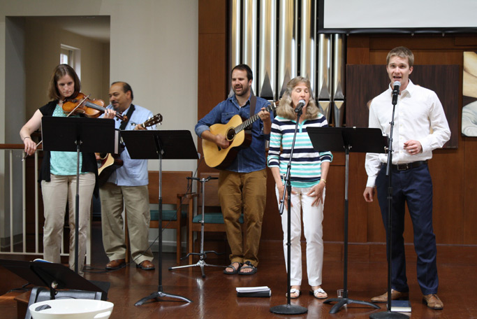 The worship team leads the evening service in song.