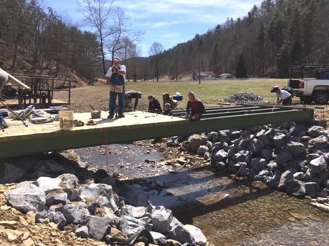 After the devastating floods in West Virginia in 2016, Community Mennonite MDS volunteers built new bridges. Courtesy of Sam Miller