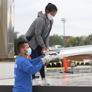 Eastern Mennonite School student Rahel Lema ‘21 and Paul Leaman, Head of School, work together during the EMS solar barnraising on October 10, 2020. See article on page 3. Photo by Andrea Wenger